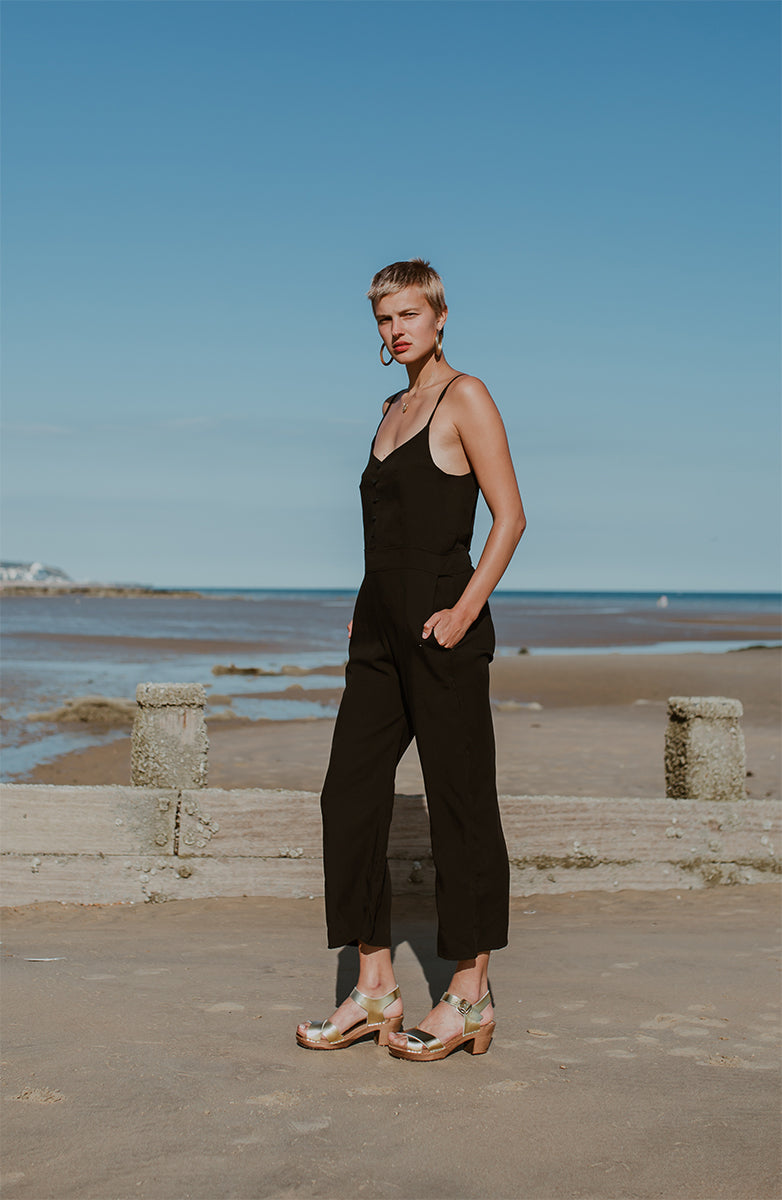 Gold metallic cross over sandal clog with ankle strap and a mid heel