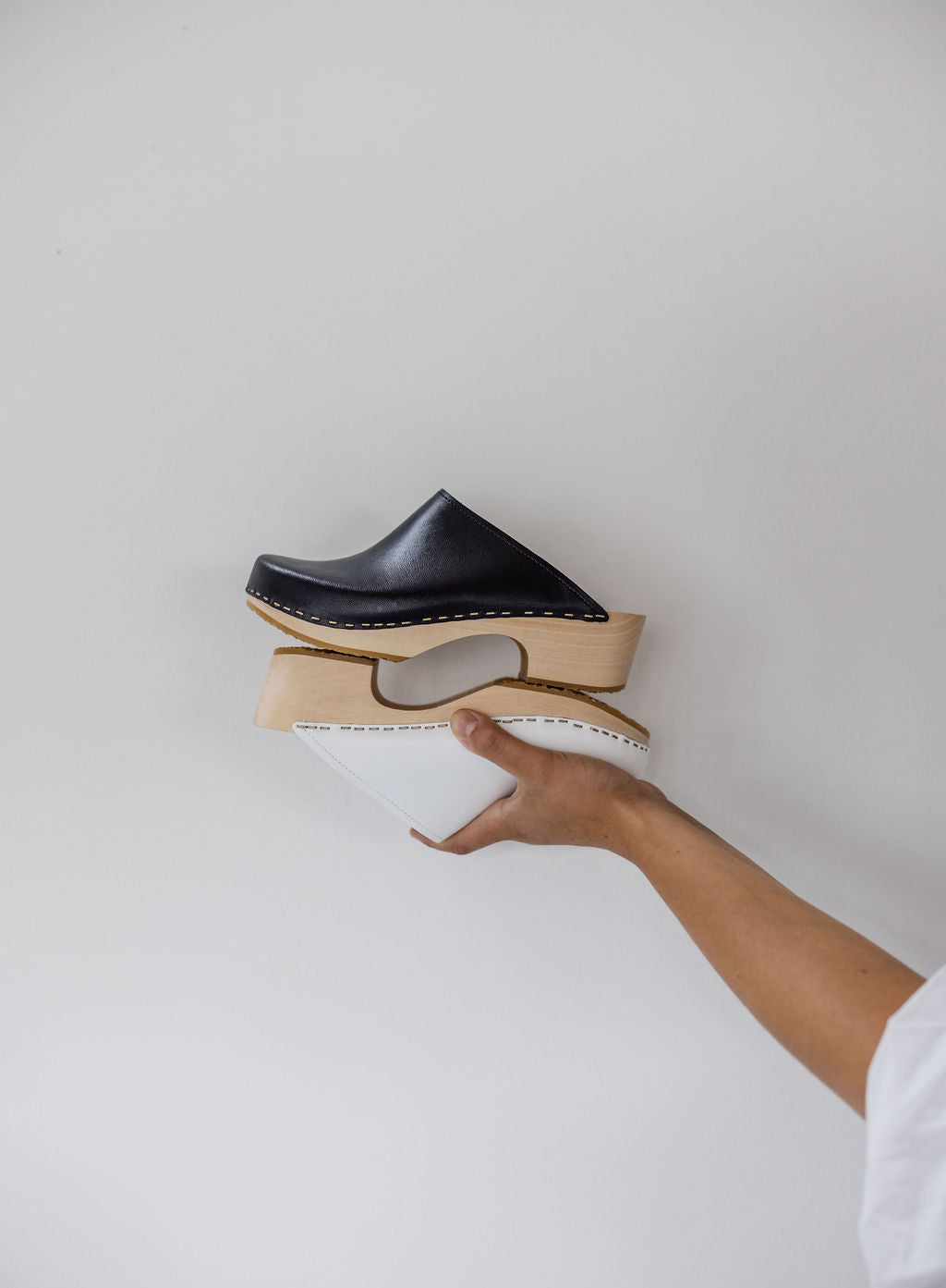 black and white womens swedish clog mules with a sleek mid heel