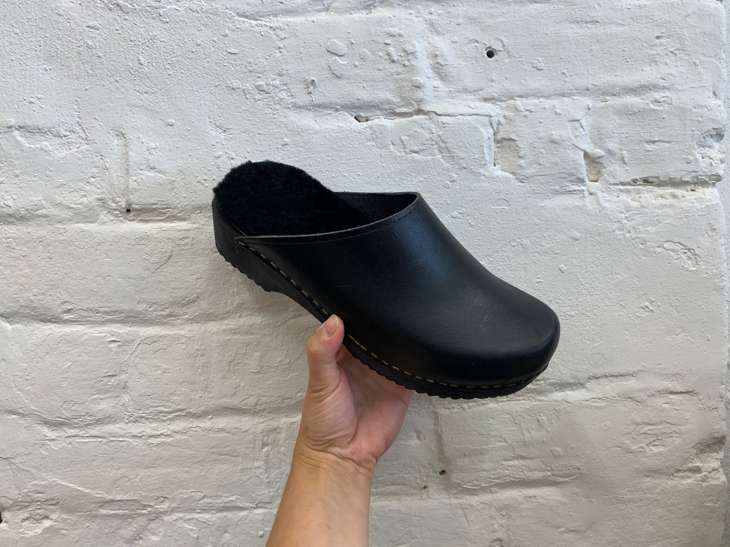 black classic style swedish clogs with a low black wooden base