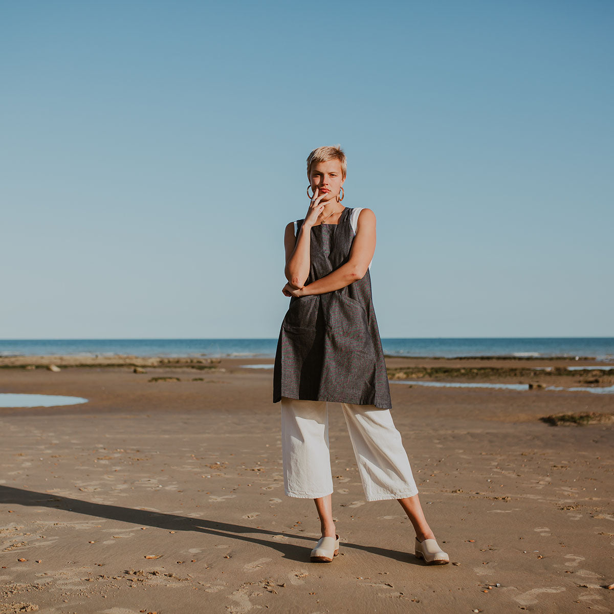 girl wears stone beige low heel clog with covered back