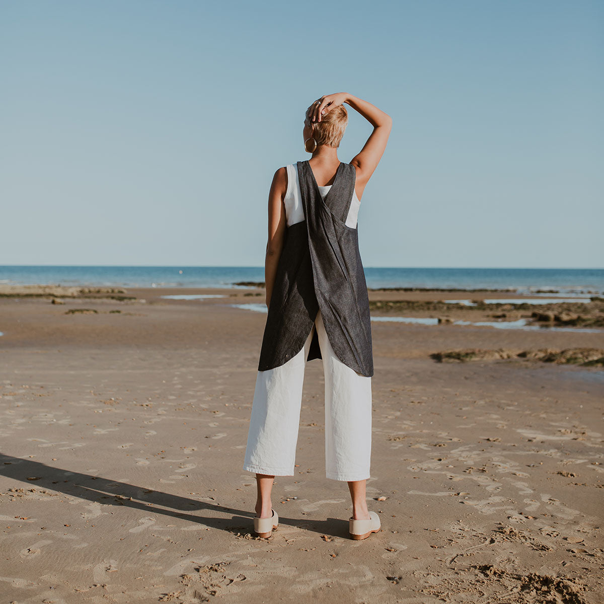 girl wears stone beige low heel clog with covered back