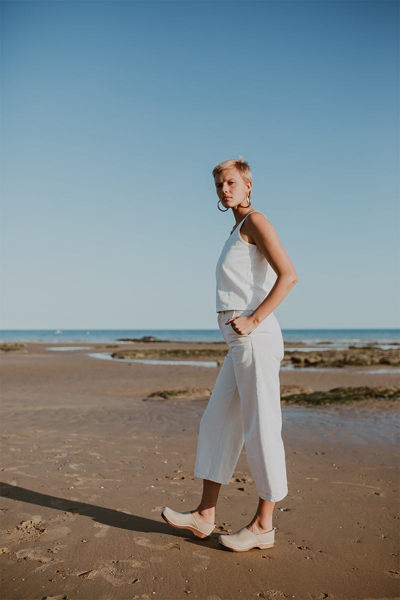 girl wears stone beige low heel clog with covered back