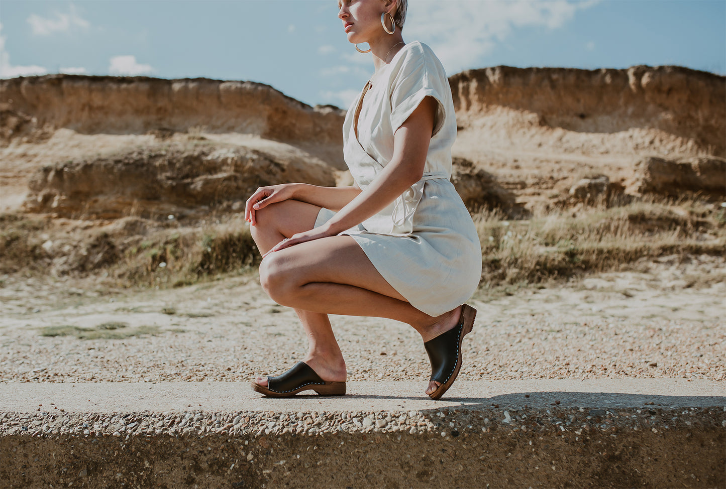 girl wears onyx black low heel clog sandal