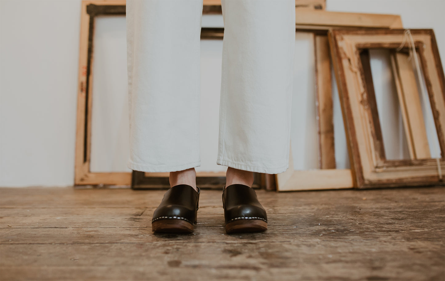 close up of woman's feet in onyx low heel clog shoe