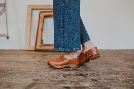 Close up of woman's feet in cumin tan low heel clog shoes