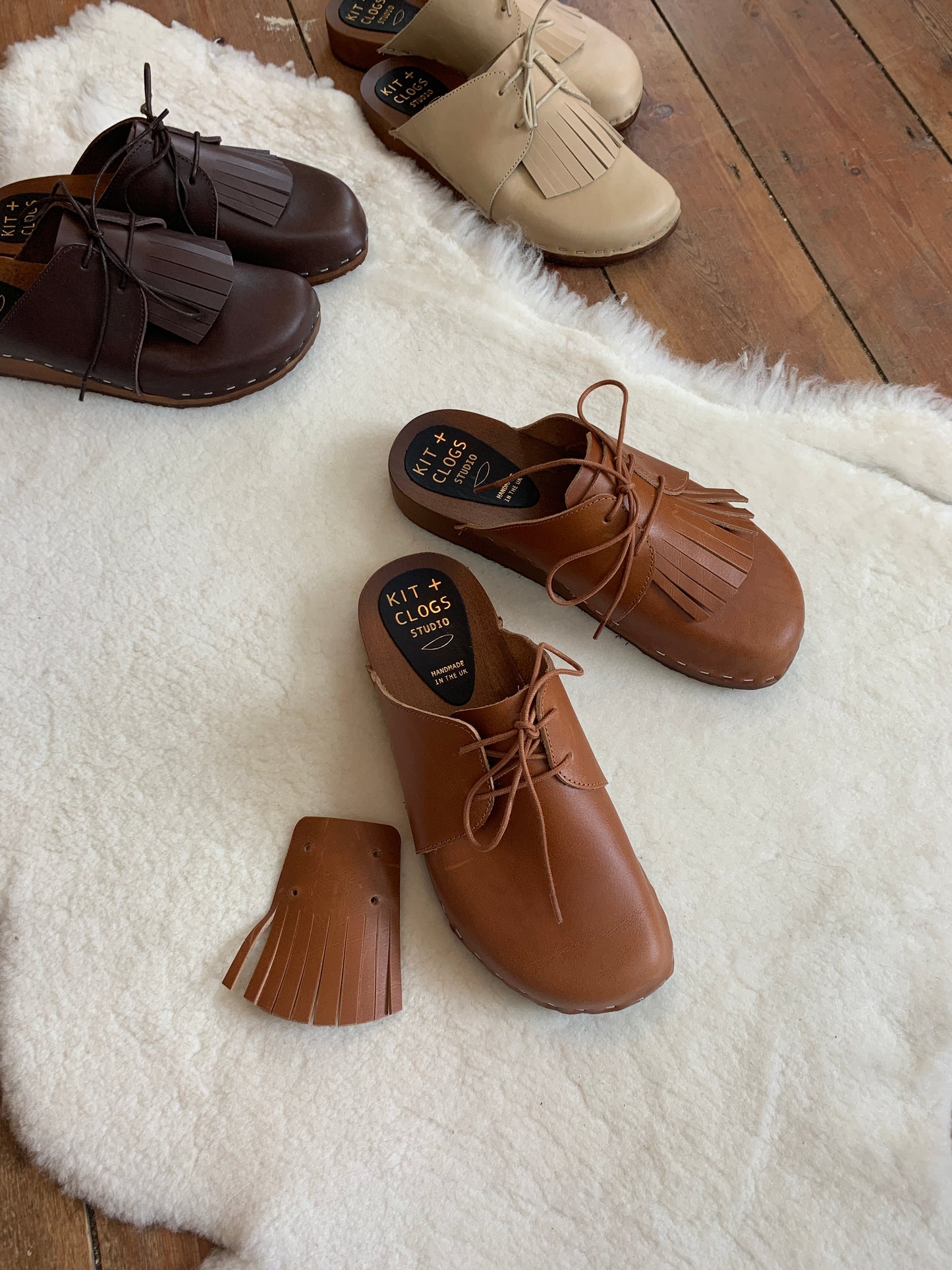 brown leather lace up clog mules with removable fringe tongue and flexible wooden base