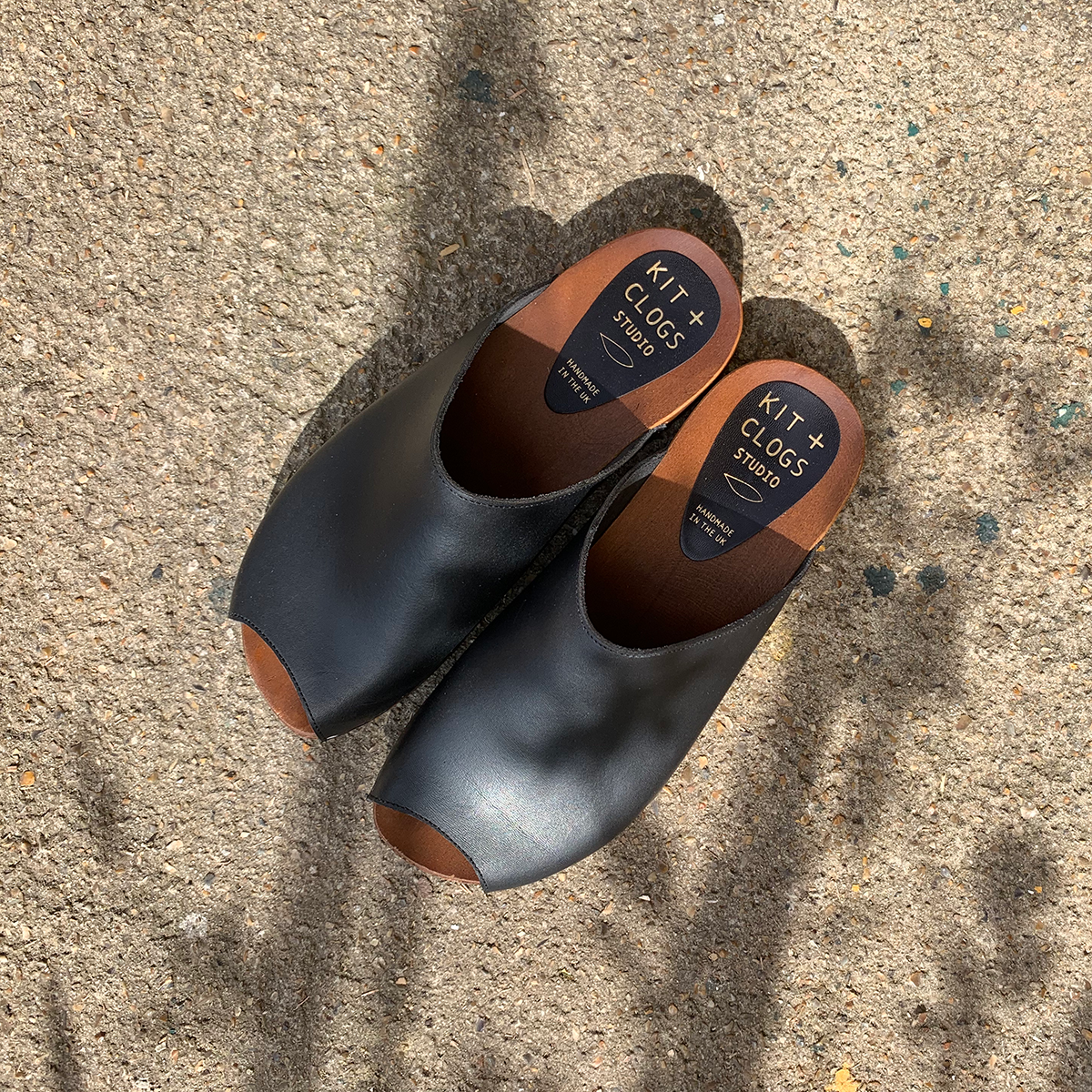 Onyx black flex base peep toe clogs sandals