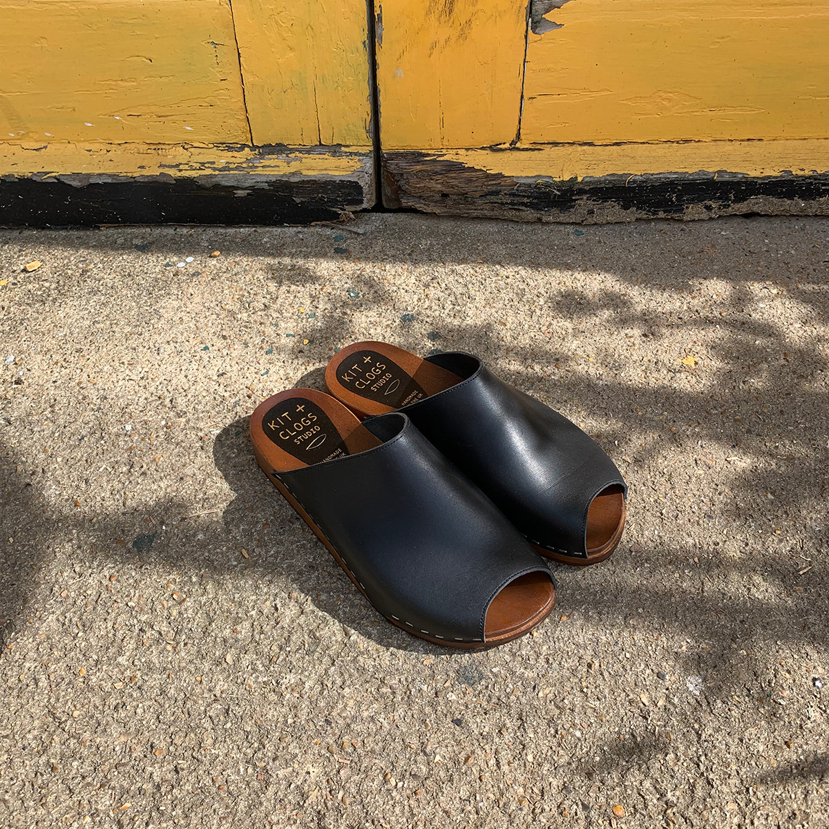 Onyx black flex base peep toe clogs sandals