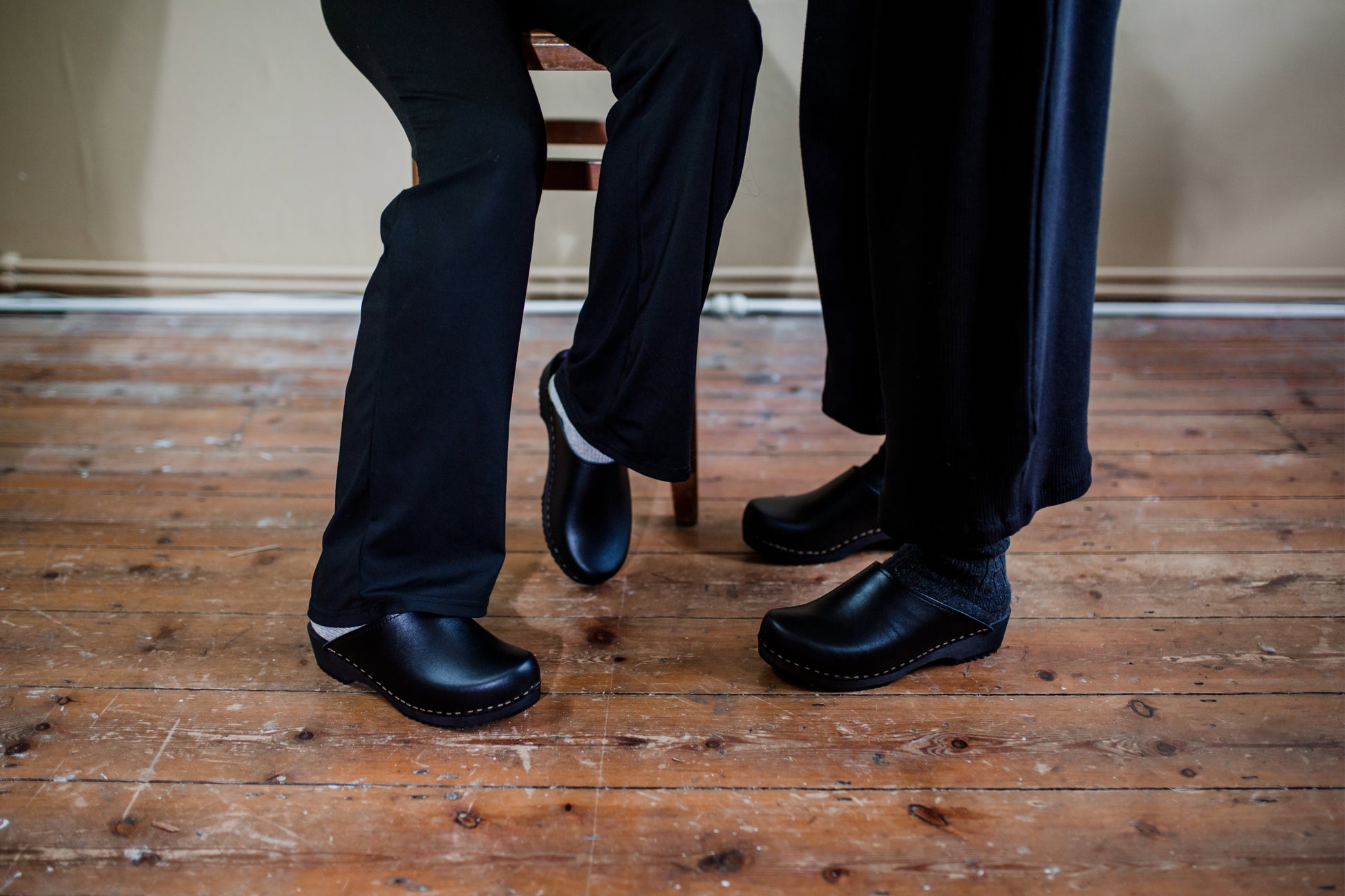 black classic style swedish clogs with a low black wooden base