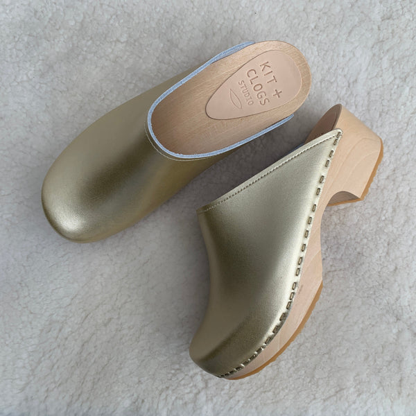 Gold classic style swedish clog with slight heel and light coloured wooden base