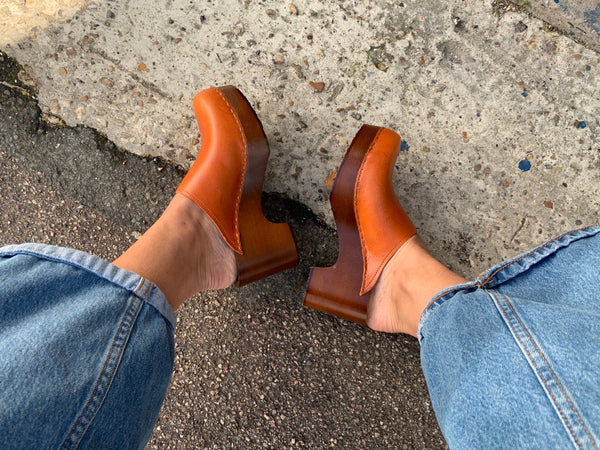 Cumin tan orange classic style swedish clogs with a dark platform base.