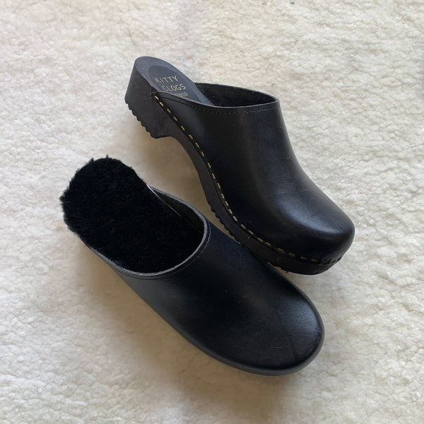 black classic style swedish clogs with a low black wooden base