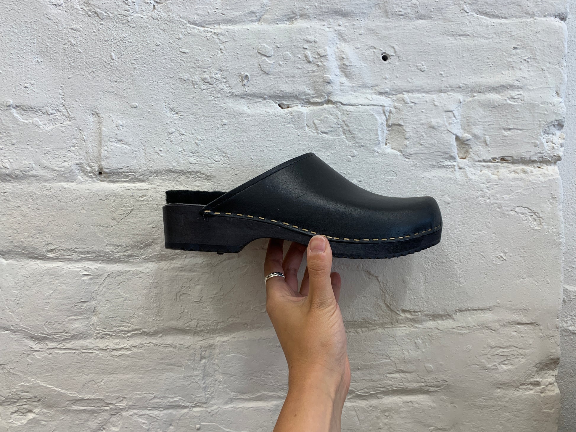 black classic style swedish clogs with a low black wooden base