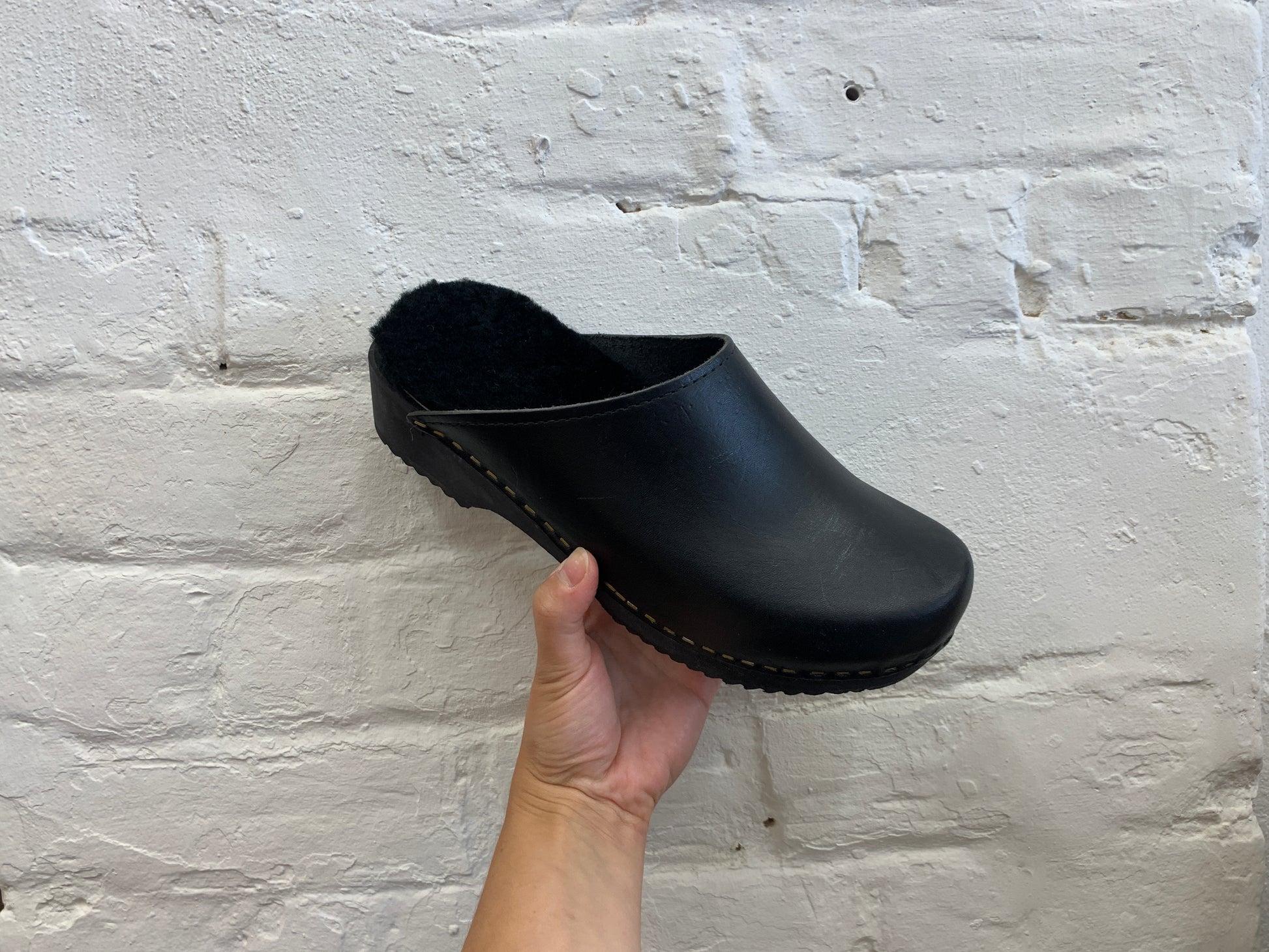 black classic style swedish clogs with a low black wooden base