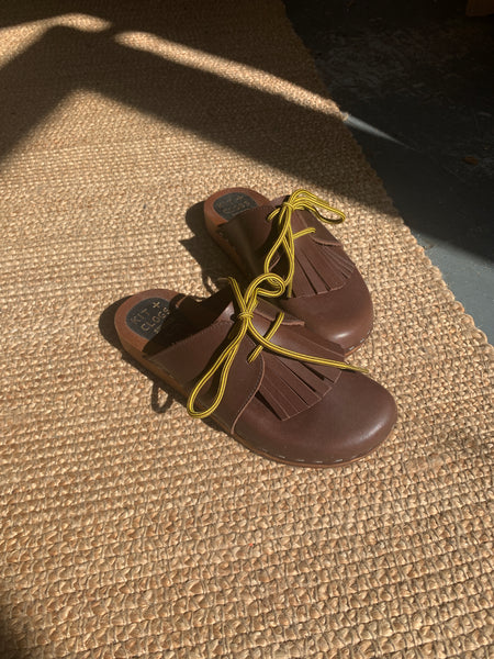 brown leather lace up clog mules with removable fringe tongue and flexible wooden base