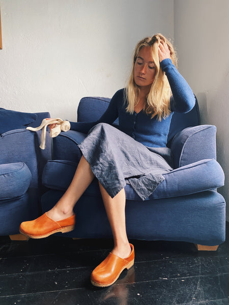Cumin tan swedish clogs with a low wooden base and covered back