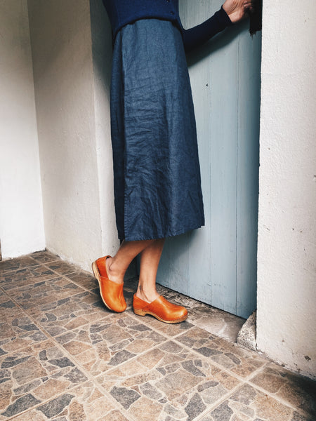 Cumin tan swedish clogs with a low wooden base and covered back