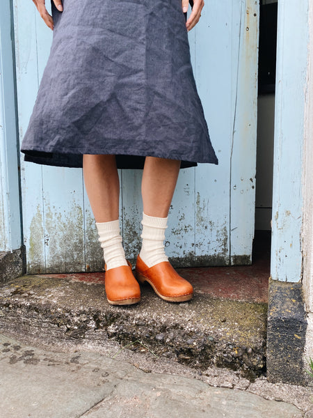 Cumin tan swedish clogs with a low wooden base and covered back