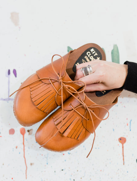 Cumin tan colour lace up mule clogs with removable fringed tongue detail anf flexible wooden base