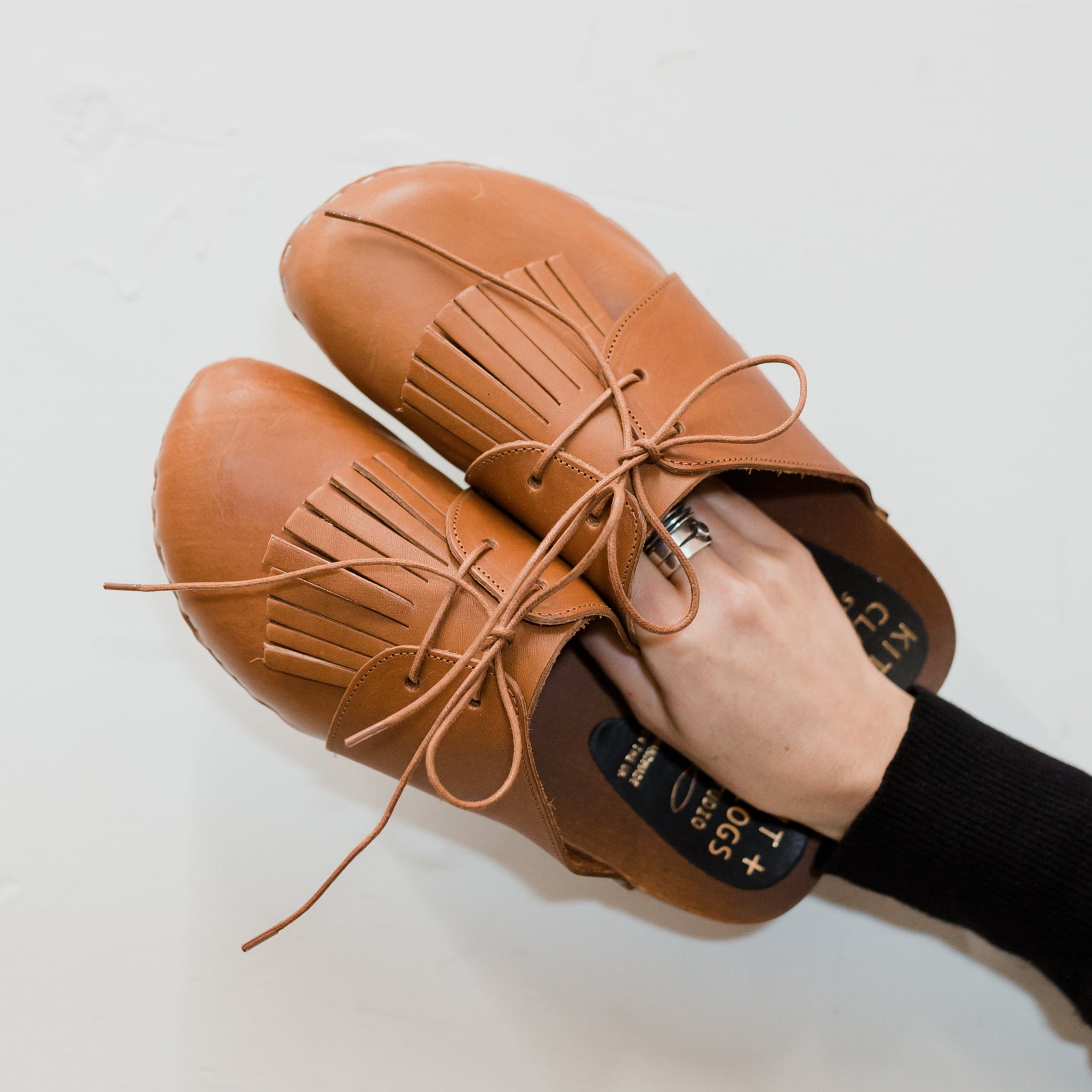 Cumin tan colour lace up mule clogs with removable fringed tongue detail anf flexible wooden base