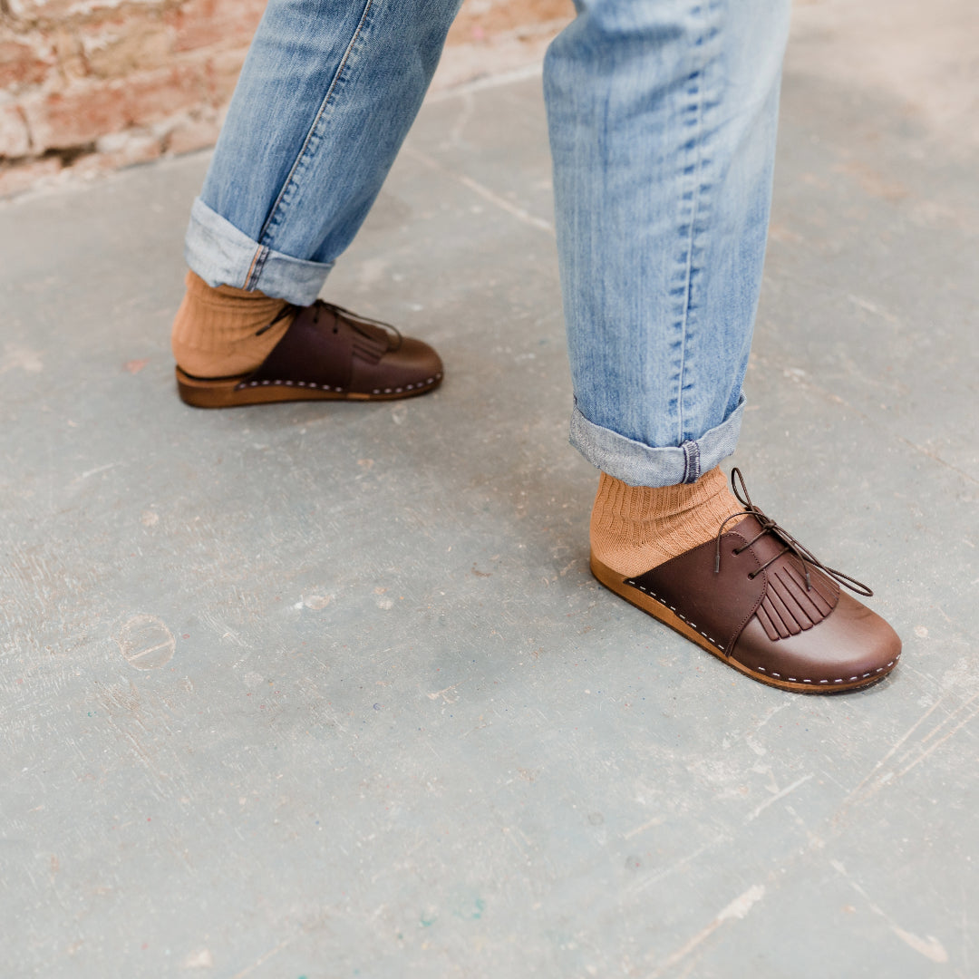 brown leather lace up clog mules with removable fringe tongue and flexible wooden base