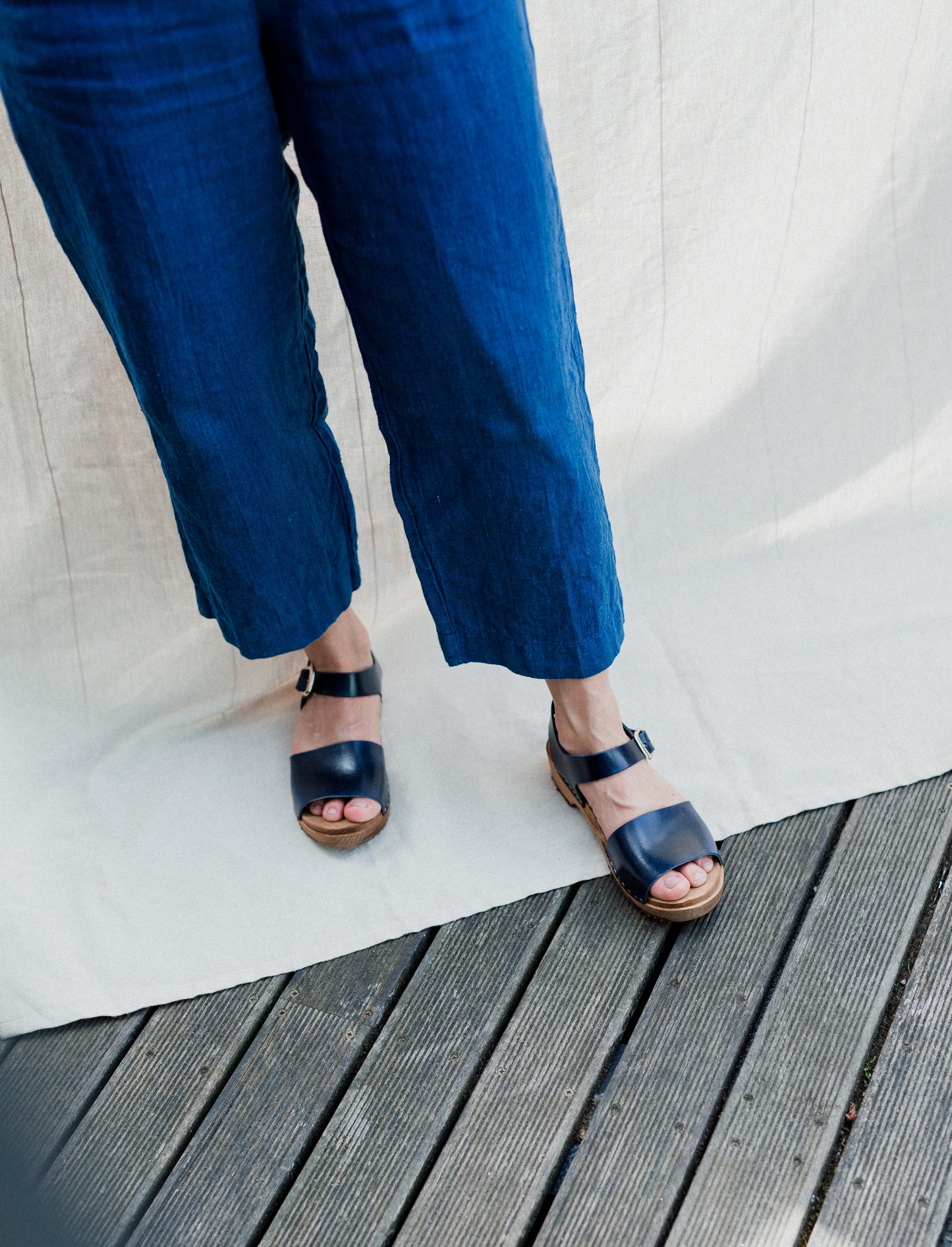 Navy blue clog sandal with ankle strap