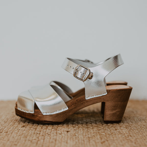 silver metallic cross over mid heel sandal clog with ankle strap