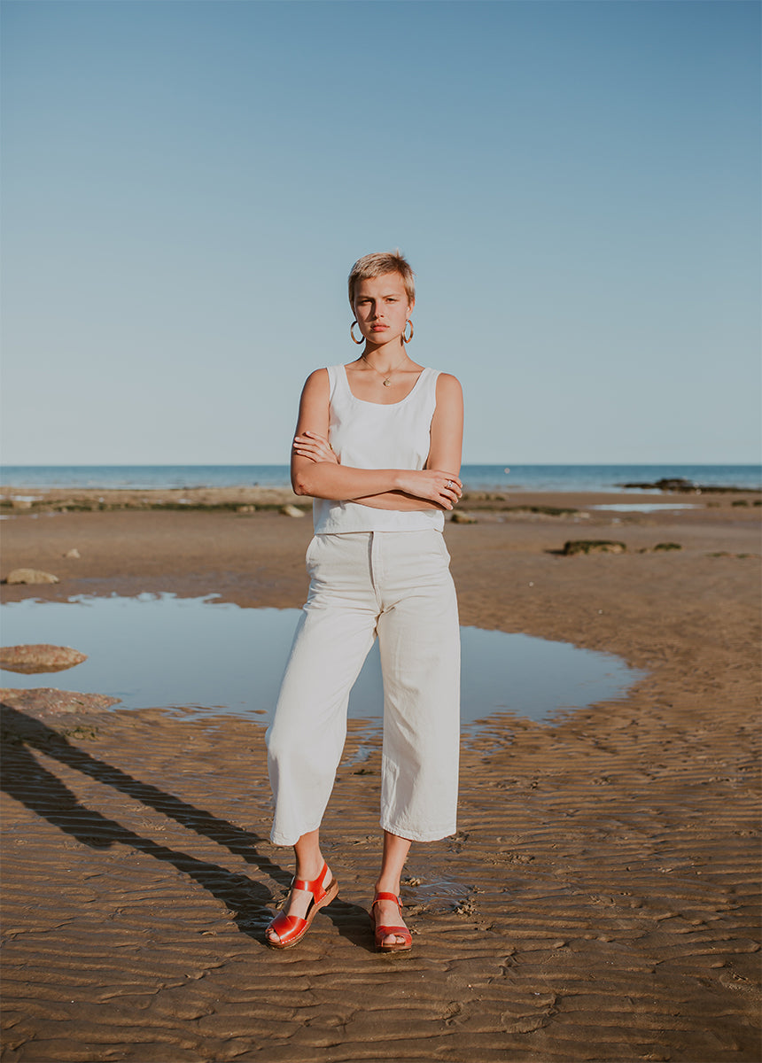 woman wears brandy red leather low cross over dansare clog sandal