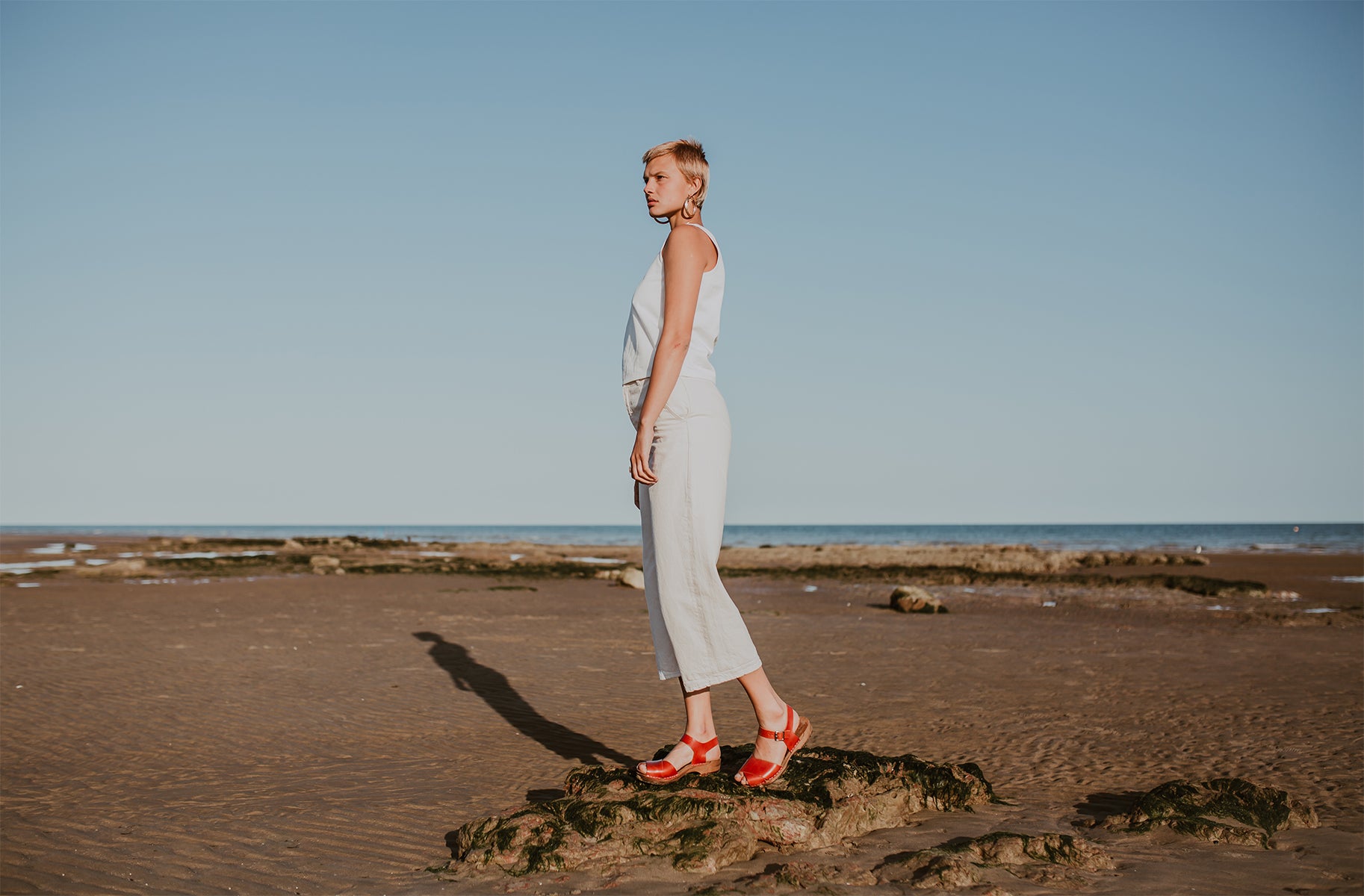 woman wears brandy red leather low cross over dansare clog sandal