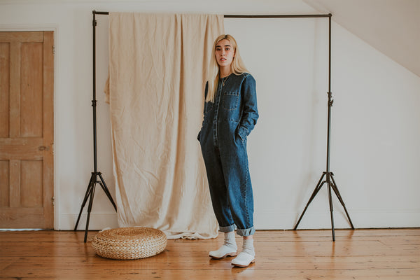 girl wears denim jumpsuit with Organic, recycled cotton socks in a flecked ash grey and cream colour with a ribbed ankle and Ice Low Klassisk clogs