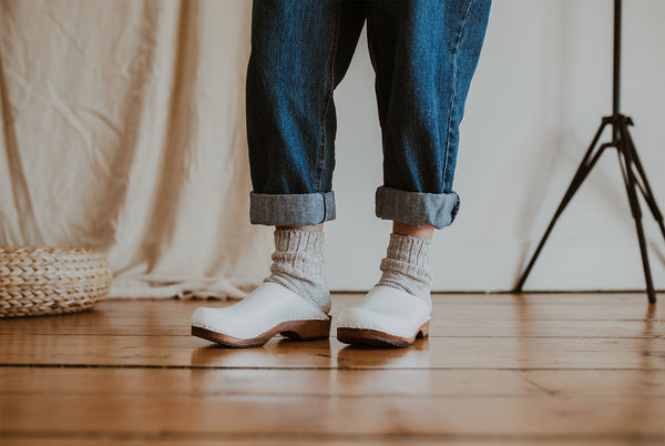 close up of woman's feet in Organic, recycled cotton socks in a flecked ash grey and cream colour with a ribbed ankle and Ice Low Klassisk clogs