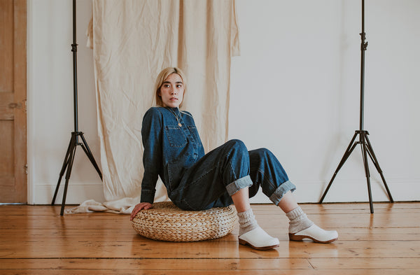 girl wears denim jumpsuit with Organic, recycled cotton socks in a flecked ash grey and cream colour with a ribbed ankle and Ice Low Klassisk clogs