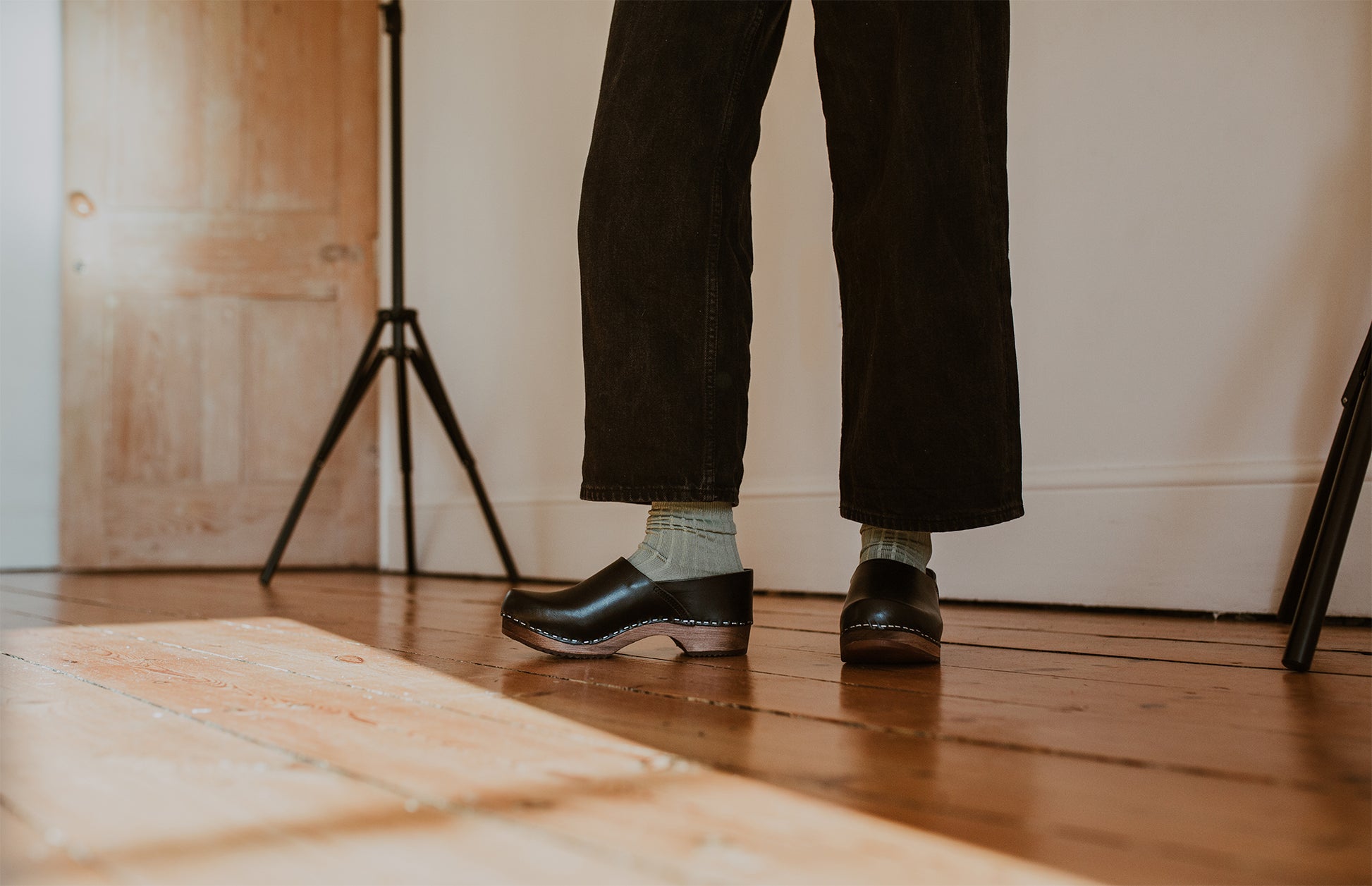 close up of woman's feet in sage green ribbed ankle socks and onyx low heel clog shoe
