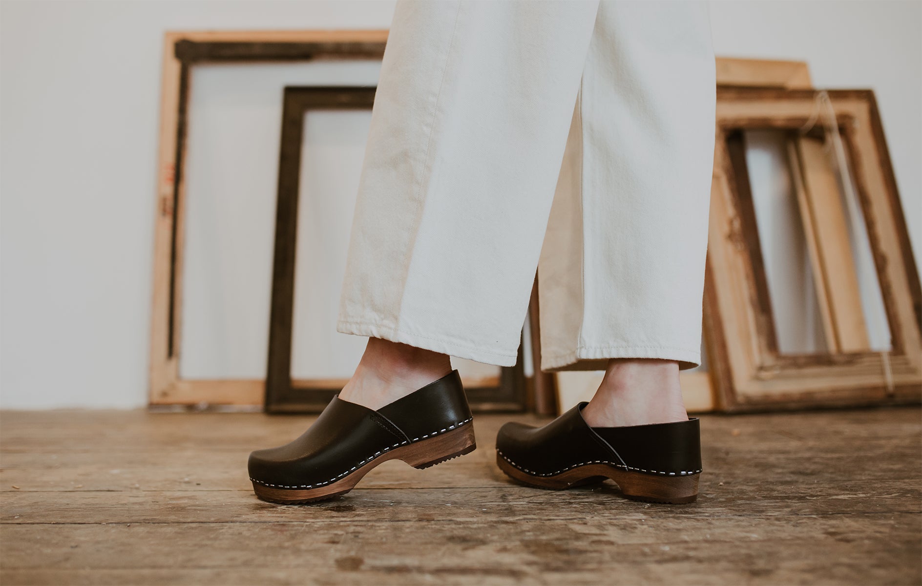 close up of woman's feet in onyx low heel clog shoe