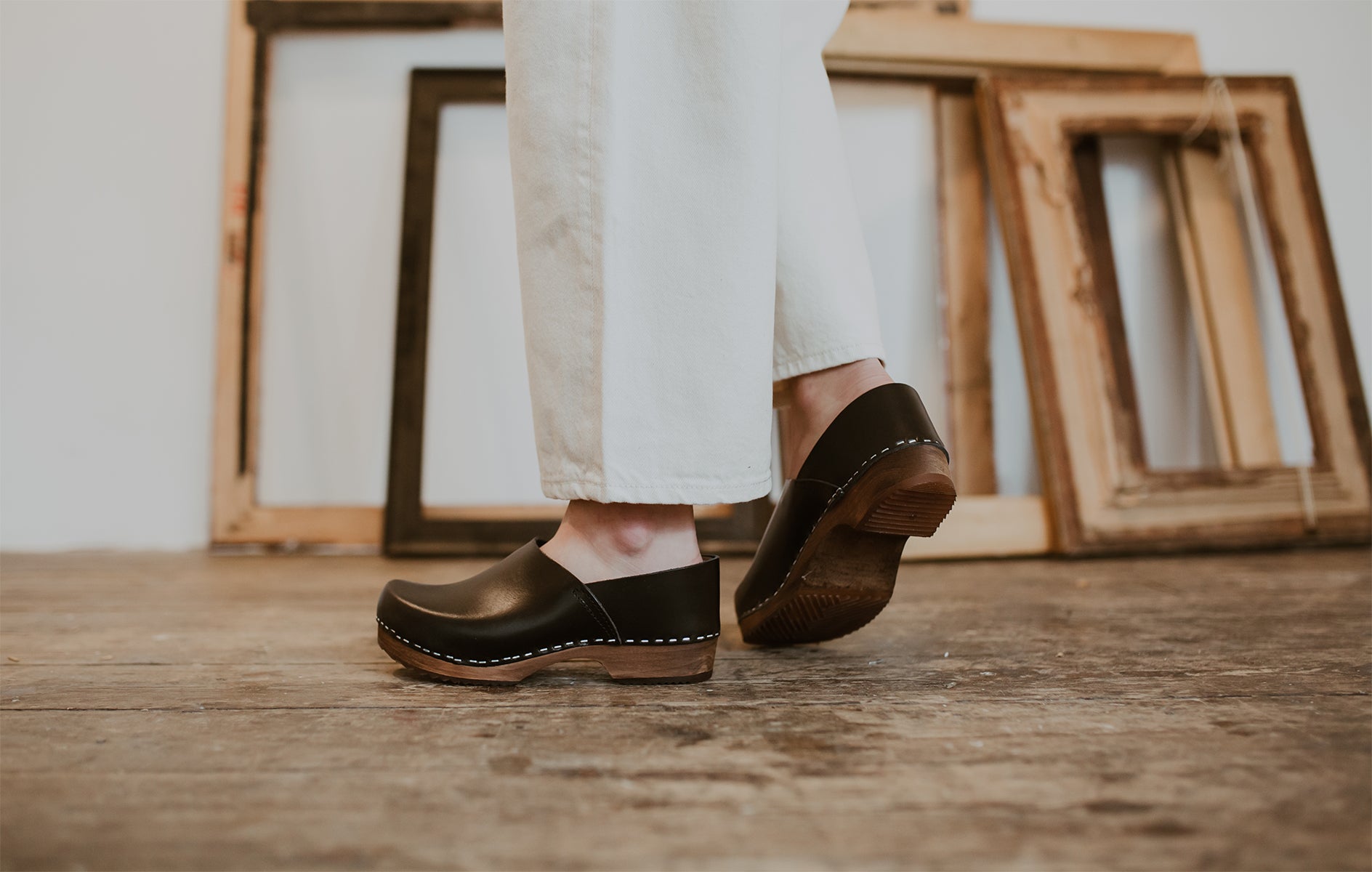 close up of woman's feet in onyx low heel clog shoe