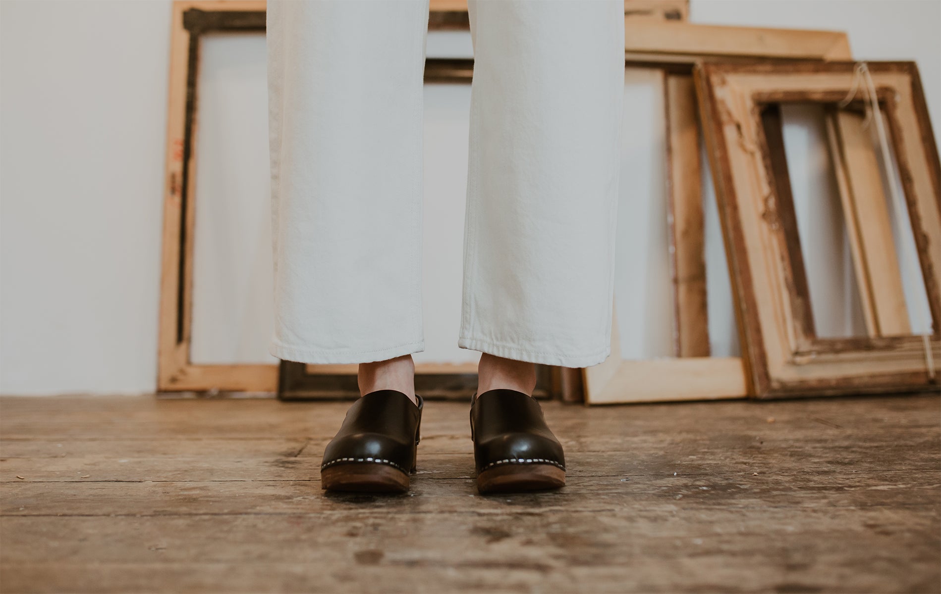 close up of woman's feet in onyx low heel clog shoe