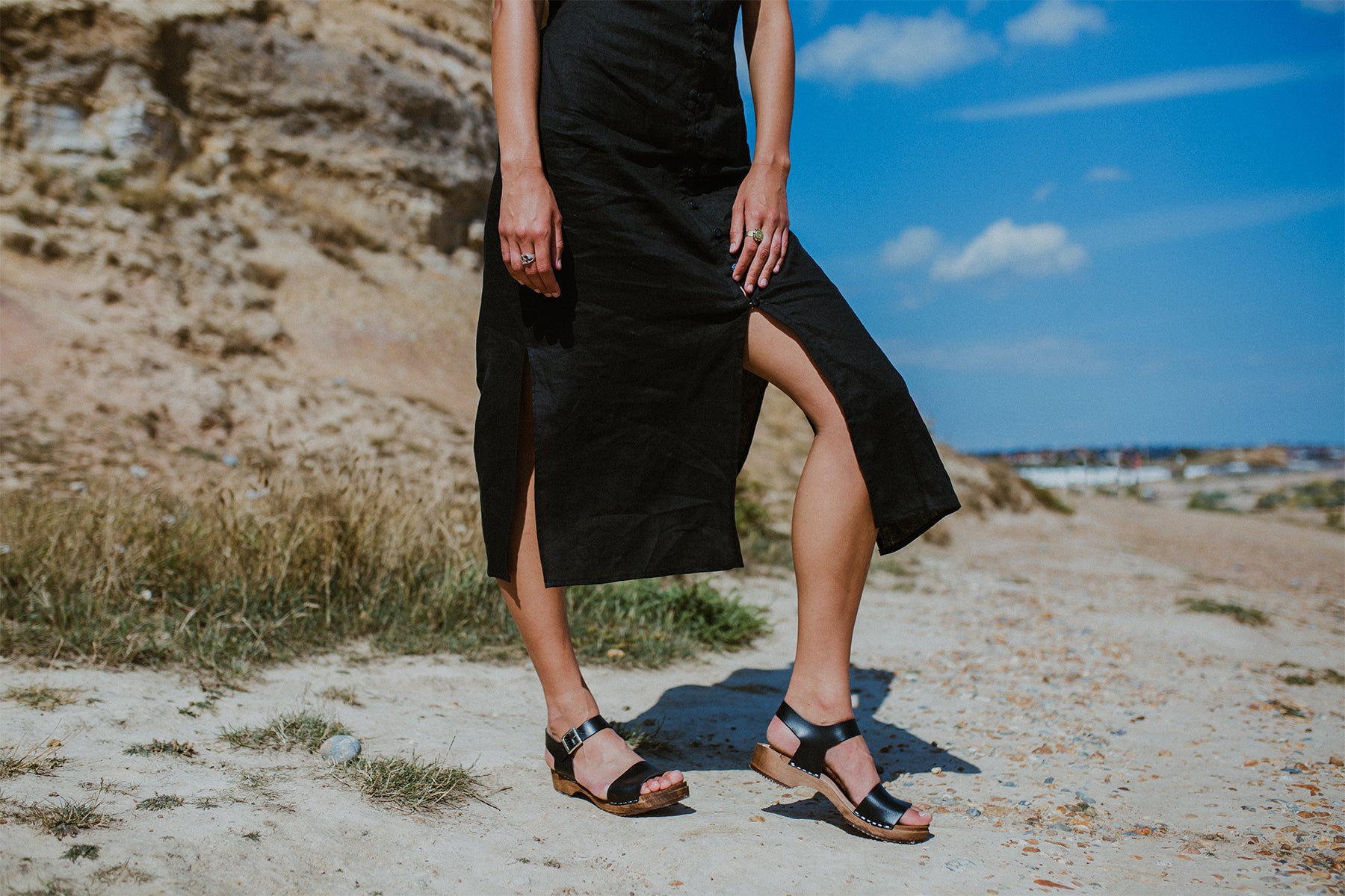 girl wears onyx black low heel single strap clog sandal