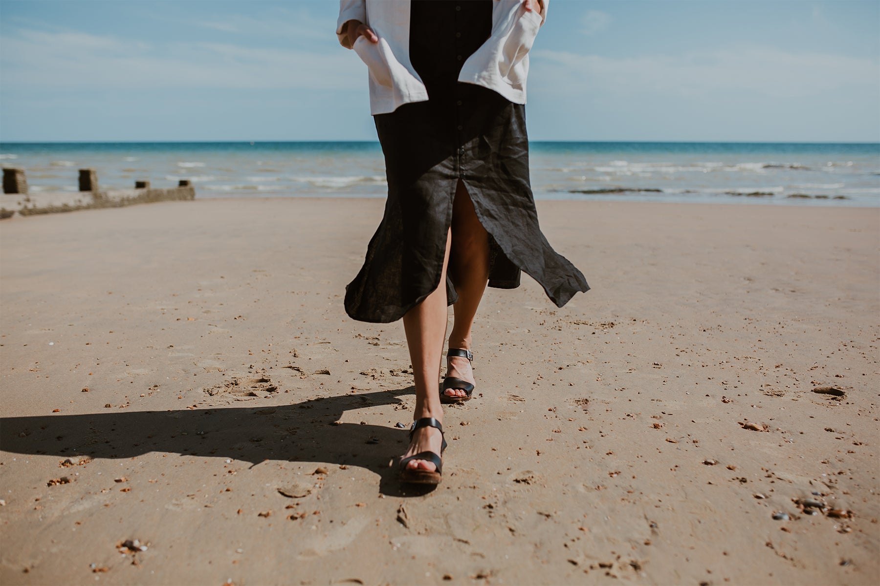 girl wears onyx black low heel single strap clog sandal