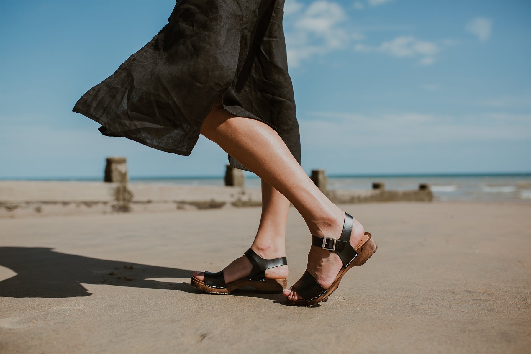 girl wears onyx black low heel single strap clog sandal