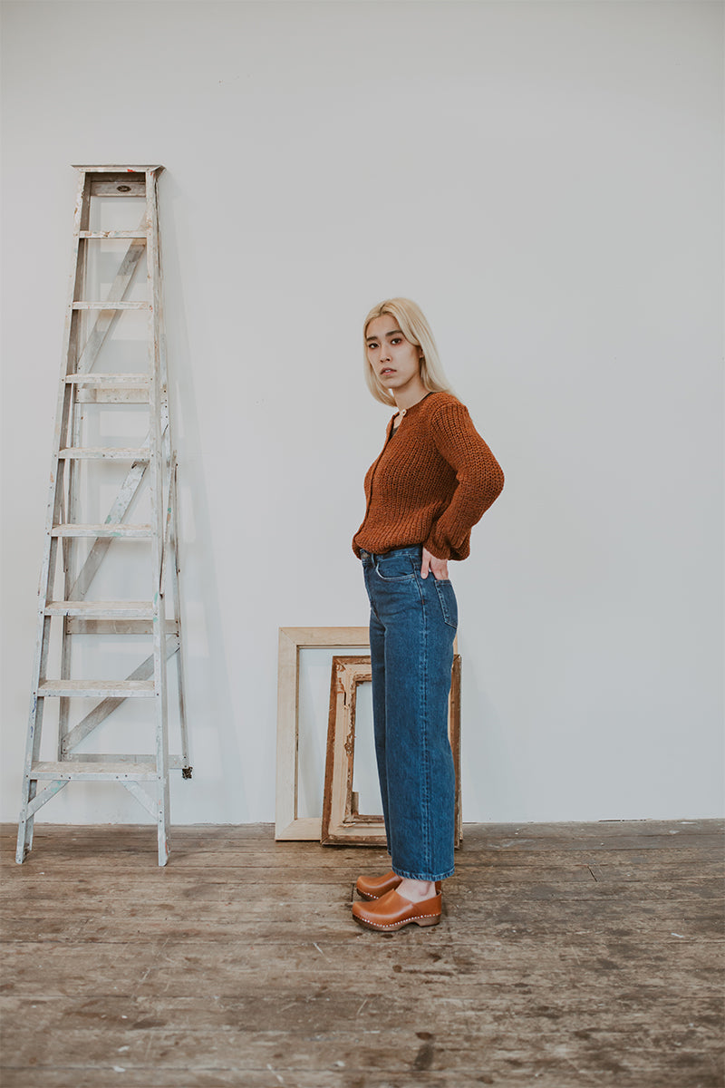 woman wears jeans and cumin tan low heel clog shoes