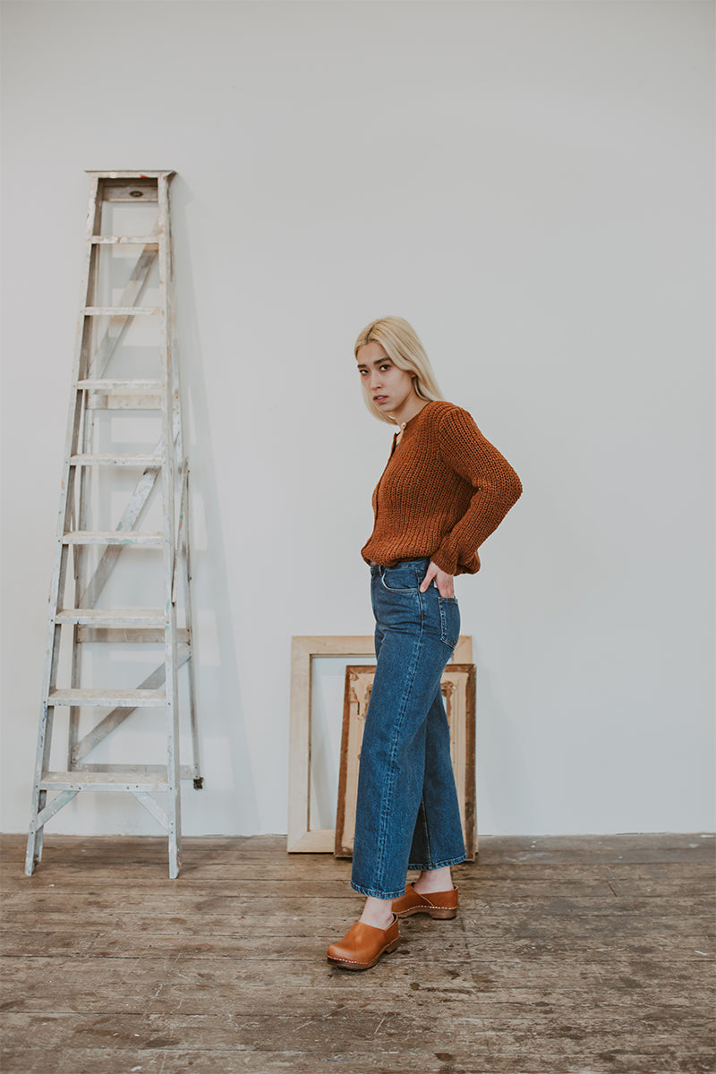 woman wears jeans and cumin tan low heel clog shoes