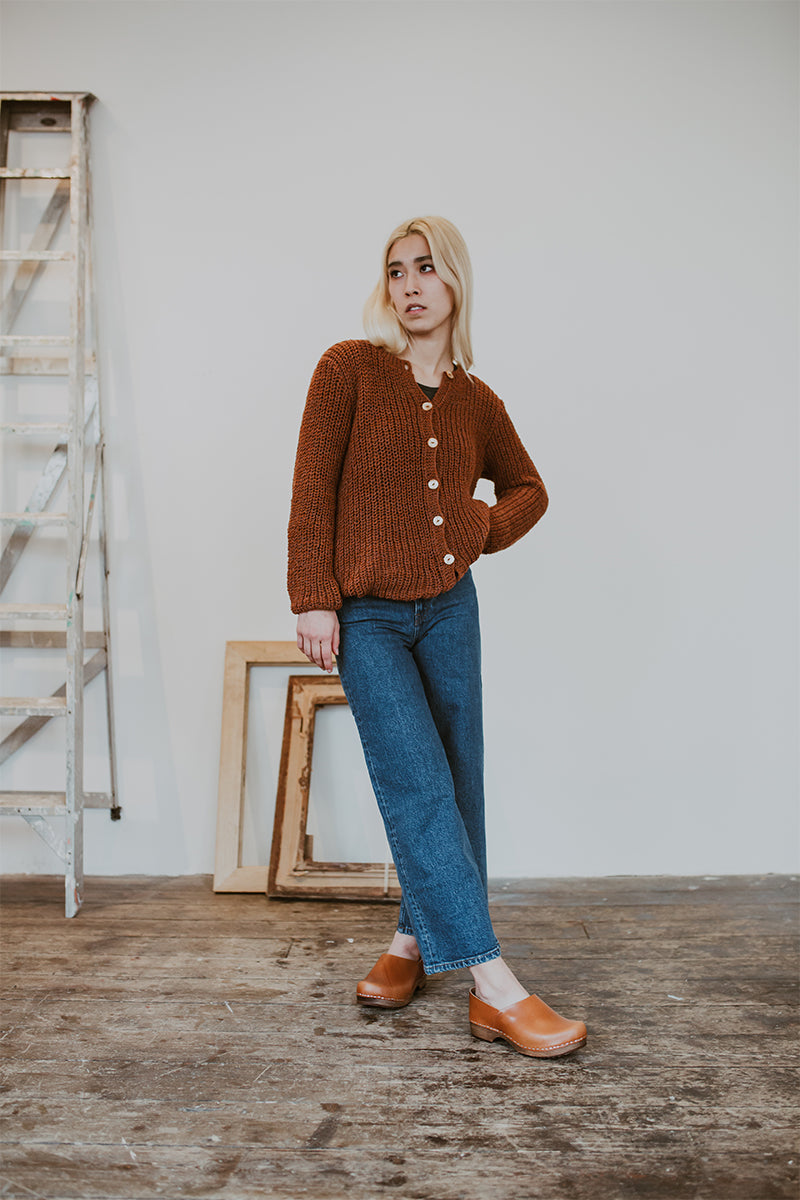 woman wears jeans and cumin tan low heel clog shoes