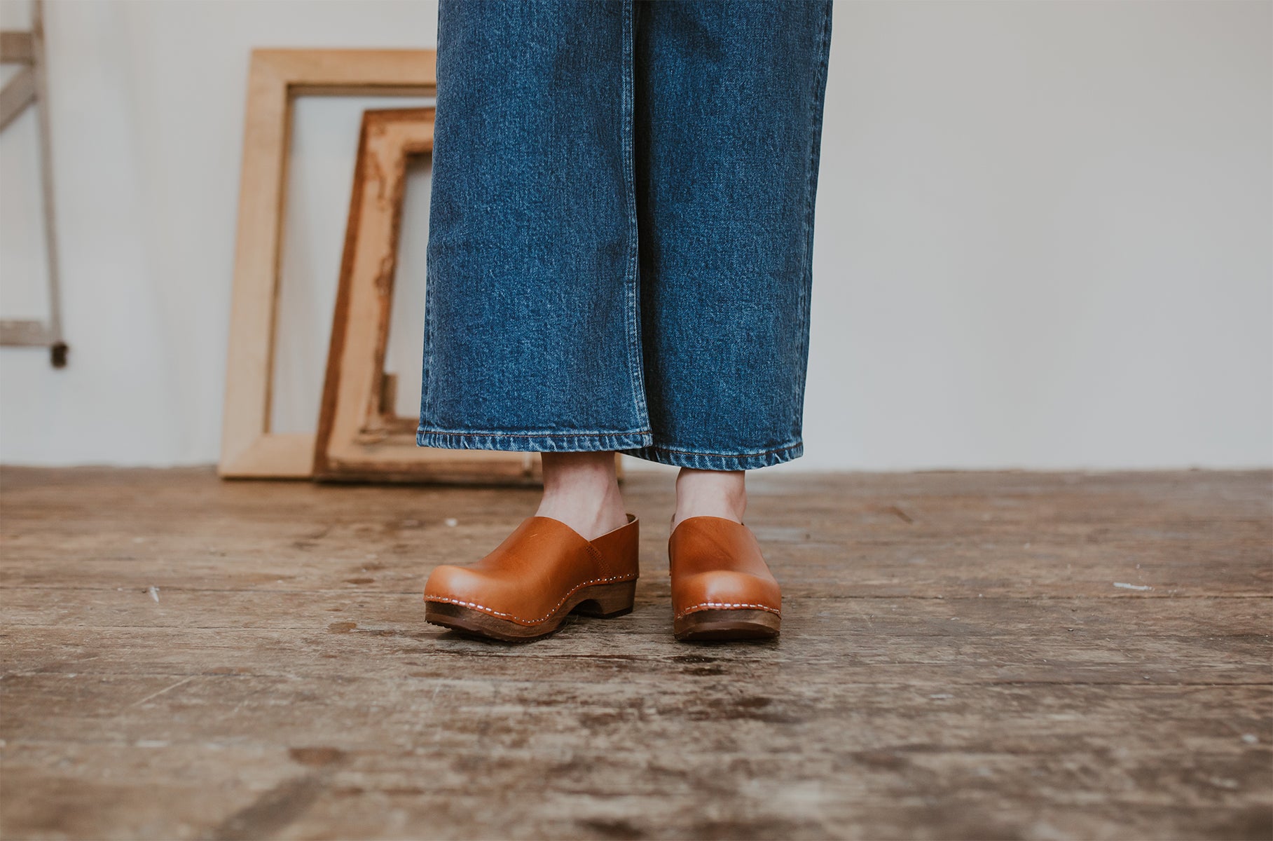 Close up of woman's feet in cumin tan low heel clog shoes