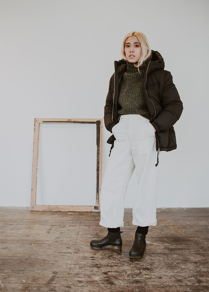 Girl wears Puffa coat and wide jeans with Black leather chelsea clog boot with flex sole