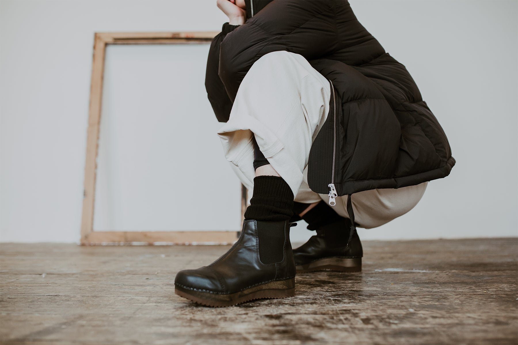Girl wears Puffa coat and wide jeans with Black leather chelsea clog boot with flex sole
