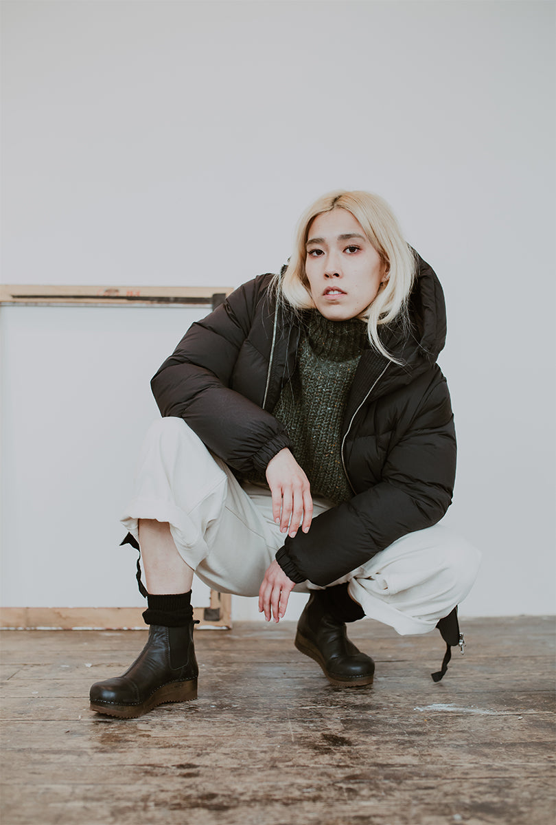 Girl wears Puffa coat and wide jeans with Black leather chelsea clog boot with flex sole