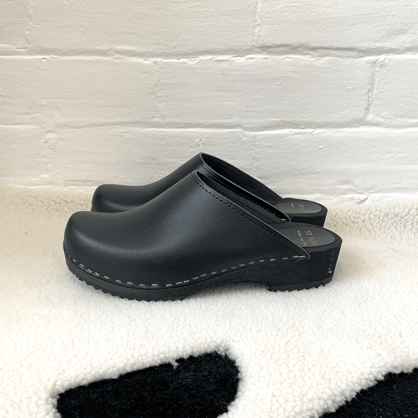 black classic style swedish clogs with a low black wooden base